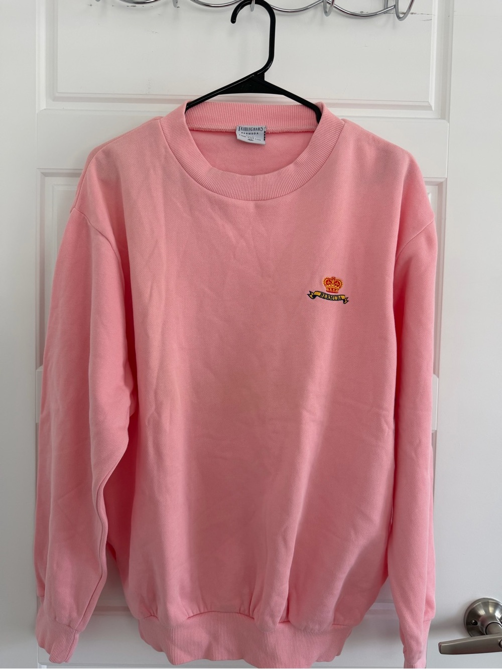 Trimingham's Vintage pink crewneck sweatshirt with embroidered logo.